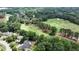Aerial view of community with golf course and mature trees at 119 Kennemer Ct, Duluth, GA 30097