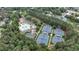 Aerial view showcasing tennis courts, swimming pool, and lush green surroundings in the community at 119 Kennemer Ct, Duluth, GA 30097