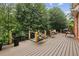 A large back deck offers ample outdoor living space amid lush greenery at 119 Kennemer Ct, Duluth, GA 30097