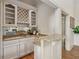 Stylish bar area with granite countertops, mirrored backsplash, and custom wine rack at 119 Kennemer Ct, Duluth, GA 30097