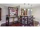 Chic bar area featuring a granite countertop, sleek cabinetry, and seating for entertaining at 119 Kennemer Ct, Duluth, GA 30097