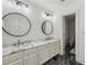 Modern bathroom featuring double sinks, marble countertops, and modern lighting fixtures at 119 Kennemer Ct, Duluth, GA 30097