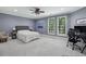Comfortable bedroom with two windows, a large bed, and a dedicated workspace at 119 Kennemer Ct, Duluth, GA 30097