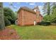 Charming exterior featuring brick facade and access to the back yard at 119 Kennemer Ct, Duluth, GA 30097