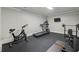 Well-equipped home gym with treadmill, stationary bike, weights, and other fitness equipment on rubber flooring at 119 Kennemer Ct, Duluth, GA 30097