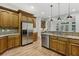 Spacious kitchen featuring stainless steel appliances, granite counters, and bar seating at 119 Kennemer Ct, Duluth, GA 30097
