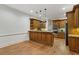 Open kitchen with wooden cabinets, granite countertops, and stainless steel appliances at 119 Kennemer Ct, Duluth, GA 30097