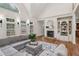 Spacious living area with hardwood floors, a fireplace, and a comfortable gray sectional sofa at 119 Kennemer Ct, Duluth, GA 30097