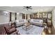 Spacious living room featuring hardwood floors, wet bar, and large area rug under the sofas at 119 Kennemer Ct, Duluth, GA 30097