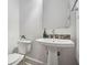 Neat half bathroom featuring a pedestal sink, modern fixtures, and decorative accents at 119 Kennemer Ct, Duluth, GA 30097