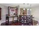 Entertainers wet bar area with modern lighting, granite counter, and seating area at 119 Kennemer Ct, Duluth, GA 30097
