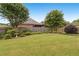 Expansive backyard featuring lush green grass, a wooden fence, and mature trees offering privacy at 2260 Burlington Ln, Snellville, GA 30078