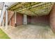 Basement access under back deck, featuring brick exterior and concrete pad at 2260 Burlington Ln, Snellville, GA 30078