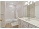 Bathroom featuring a tub, a white vanity with a large mirror, toilet and floral wallpaper at 2260 Burlington Ln, Snellville, GA 30078