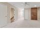 Spacious bedroom features neutral carpeting, a brick accent wall, and an overhead fan at 2260 Burlington Ln, Snellville, GA 30078
