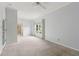 Bright bedroom featuring neutral walls, carpet, ceiling fan and a large window at 2260 Burlington Ln, Snellville, GA 30078