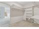Walk-in closet with open shelving and hanging rods for ample storage at 2260 Burlington Ln, Snellville, GA 30078
