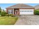 Charming one-story brick home featuring an attached two-car garage and manicured front lawn at 2260 Burlington Ln, Snellville, GA 30078
