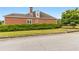 Street view of home exterior showing the manicured lawn and mature hedges in front of a brick house at 2260 Burlington Ln, Snellville, GA 30078