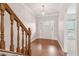 Foyer with hardwood flooring, stairs, and an elegant chandelier at 2260 Burlington Ln, Snellville, GA 30078