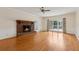 Spacious living room with hardwood floors, brick fireplace, and access to an outdoor deck area at 2260 Burlington Ln, Snellville, GA 30078