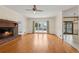 Open living room with hardwood flooring, brick fireplace, and direct access to a back deck at 2260 Burlington Ln, Snellville, GA 30078