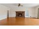 Bright living area features hardwood floors, a brick fireplace, and access to other rooms in the house at 2260 Burlington Ln, Snellville, GA 30078
