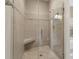 Modern tiled shower with glass door and a built-in seat offering a spa-like experience at 2260 Burlington Ln, Snellville, GA 30078