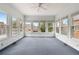 A spacious sunroom featuring a ceiling fan and abundant natural light through large windows at 2260 Burlington Ln, Snellville, GA 30078