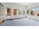 An empty, window-lined sunroom with a door to the outside porch at 2260 Burlington Ln, Snellville, GA 30078