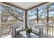 Relaxing covered balcony with outdoor seating, a view of the surrounding trees, and lots of light at 2700 Pine Tree Ne Rd # 2201, Atlanta, GA 30324