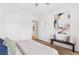 Cozy bedroom with an open doorway, bench with accent pillows, and abstract art on the wall at 2700 Pine Tree Ne Rd # 2201, Atlanta, GA 30324