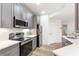 Well-lit kitchen featuring stainless steel appliances and sleek gray cabinets at 2700 Pine Tree Ne Rd # 2201, Atlanta, GA 30324