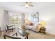 Bright living room featuring a ceiling fan, modern furniture, area rug, and a large window at 2700 Pine Tree Ne Rd # 2201, Atlanta, GA 30324