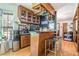 Stylish bar area with wooden cabinets, hardwood floors, and decorative glass storage above the counter at 2969 White Ne Rd, Conyers, GA 30012