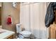 Cozy bathroom features toilet, shower with patterned curtain, and sink at 2969 White Ne Rd, Conyers, GA 30012