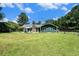 Spacious property featuring a house with a stone chimney, a gazebo, and lush greenery at 2969 White Ne Rd, Conyers, GA 30012