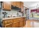 Efficient kitchen with wood cabinets, modern appliances, laminate countertops and view to the dining area at 2969 White Ne Rd, Conyers, GA 30012