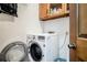 Convenient laundry room with washer, dryer, and overhead storage at 2969 White Ne Rd, Conyers, GA 30012