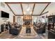 Spacious living room with vaulted ceilings, wood beams, stone fireplace, and cozy seating at 2969 White Ne Rd, Conyers, GA 30012
