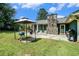 Back patio with a stone fireplace, outdoor grill, and seating, perfect for outdoor enjoyment at 2969 White Ne Rd, Conyers, GA 30012