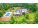 Back view of home featuring an in-ground pool and spacious backyard in a private, wooded setting at 326 Seldom Seen Trl, Canton, GA 30115