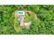 Aerial view of home featuring an in-ground pool, and long driveway, nestled in a wooded setting at 326 Seldom Seen Trl, Canton, GA 30115
