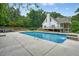 Beautiful home exterior with a large inground pool and lush landscaping at 326 Seldom Seen Trl, Canton, GA 30115