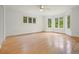 Bright, empty bedroom with hardwood floors, large windows, and white walls at 326 Seldom Seen Trl, Canton, GA 30115