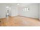 Empty bedroom with hardwood floors, white walls, white trim and large window at 326 Seldom Seen Trl, Canton, GA 30115