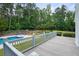 Gray deck with pool view and backyard seating, perfect for outdoor entertaining at 326 Seldom Seen Trl, Canton, GA 30115