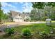 Two-story home with a long driveway, lush landscaping, and fenced yard at 326 Seldom Seen Trl, Canton, GA 30115