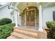 Inviting front entryway with stone accents, brick stairs, and double doors at 326 Seldom Seen Trl, Canton, GA 30115