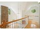 Bright hallway with hardwood floors, a stone fireplace, and unique windows at 326 Seldom Seen Trl, Canton, GA 30115
